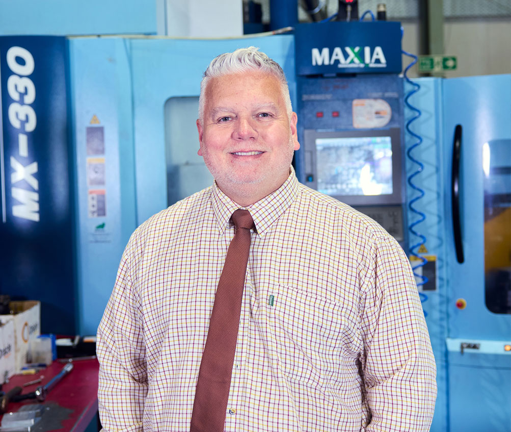 Shaun Palmer - Commercial Director of Oracle Precision stood in front of a CNC Milling Machine